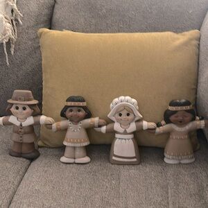 Thanksgiving hand holding pilgrims and native Americans